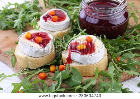 Cheese Saint-mor-de-touren With Raspberry Jam On White Wooden Background