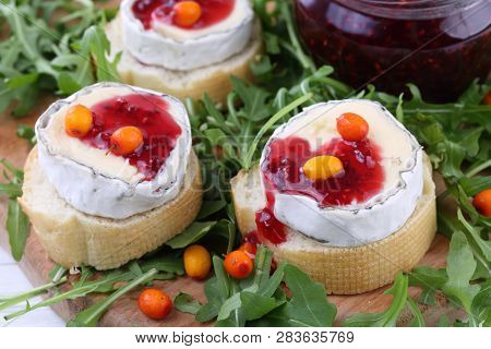 Cheese Saint-mor-de-touren With Raspberry Jam On White Wooden Background