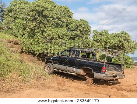Kapaa, Kauai - January 18, 2019: Abandoned Truck On Beach Being Towed By Contractor