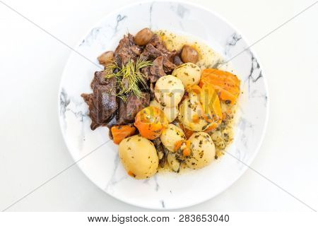 Beef meat stewed with potatoes-Traditional French cuisine Beef Bourguignon potatoes carrots in persillade