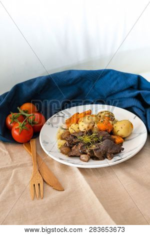 Beef meat stewed with potatoes-Traditional French cuisine Beef Bourguignon potatoes carrots in persillade