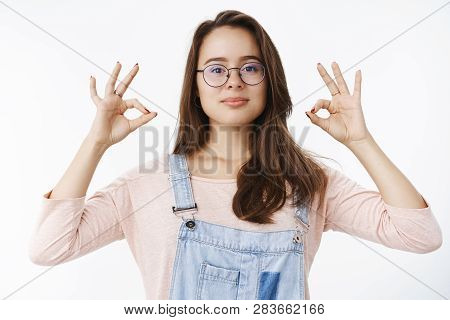 Everything Ok. Confident Assertive Female Professional In Overalls And Glasses Assuring Work Going G