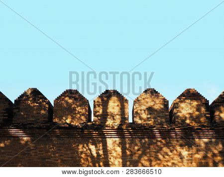 Brick Wall Strusture With Tree Shadow Over Clear Blue Sky Background.
