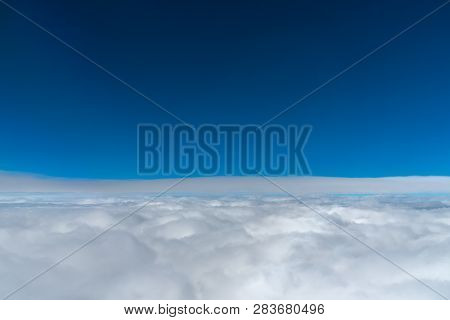Dark Blue Sky Horizon, Up In The Air. Viewed From An Airplane Window.