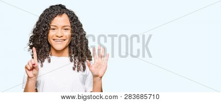 Young beautiful woman with curly hair wearing white t-shirt showing and pointing up with fingers number six while smiling confident and happy.