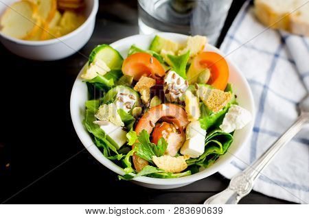 Fresh Light Green Salad With Cucumber, Lettuce, Avocado, Tomatoes, Cheeseand Sseeds And Glass Water 