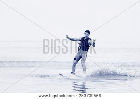 Happy Man Waterskiing And Having Fun. Living A Healthy Lifestyle And Staying Active. Doing Water Spo