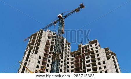 Crane. Construction Crane. Building Crane On The Background Of The Building.