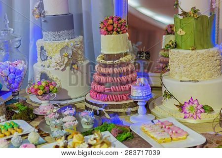 Wedding Cake And Specific Sweets Decorated With Artificial Flowers And Painted.