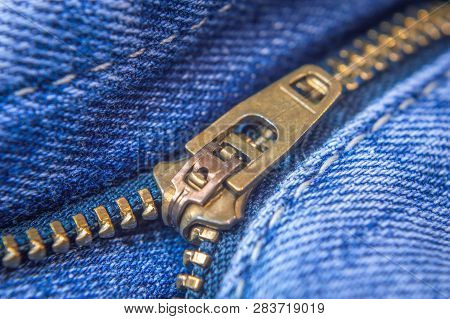 Close Up Of An Unzipped Blue Jeans Denims. Zip Lock Close Up.