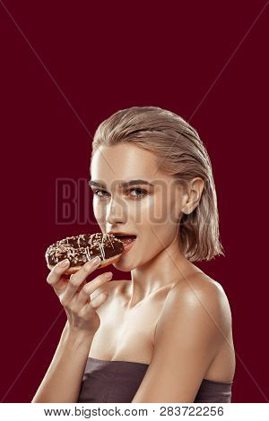 Dark-eyed Model Looking Sexy While Biting Piece Of Doughnut