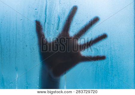 A Hand On The Sweaty Fogged Window. Water Droplets Condensation Background Of Dew On Glass, Humidity