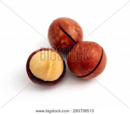 Macadamia Nut With A Cut On A Shell, Isolated On White Background.