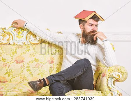Macho Sits With Open Book On Head, Like Roof. Boring Literature Concept. Man With Beard And Mustache