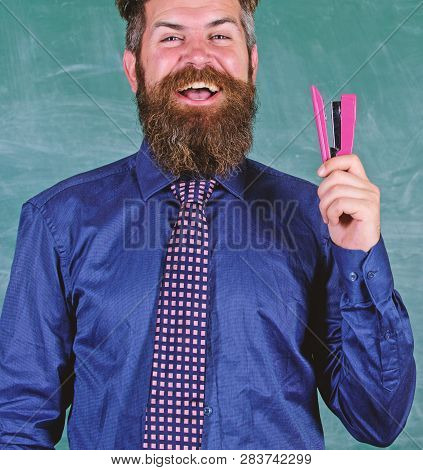 School Stationery. Man Smiling Hold Stapler Stationery. Hipster Teacher Formal Necktie Holds Stapler