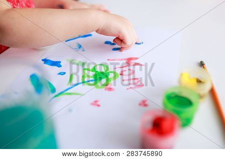 Easter Eggs On White Wooden Background. Flowers And Candies Around.