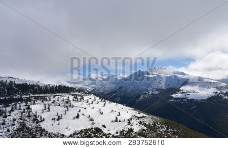 Winter Landscape With Snowy Mountains And Cloudy Grey Sky. Ancares, Lugo, Galicia, Spain.