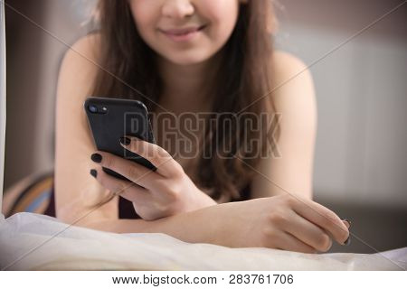 Close-up Of Woman Taking Myostimulation, Smiling And Holding Her Phone At The Nutritionists Office