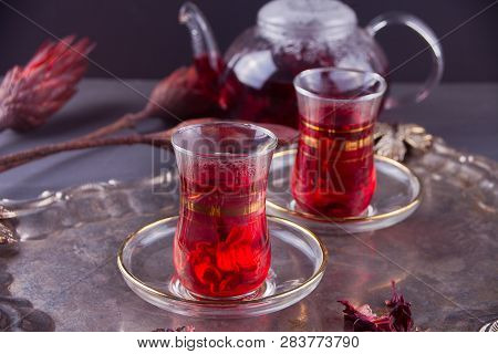 Cups Of Hot Red Karkade Tea With Teapot On The Tray