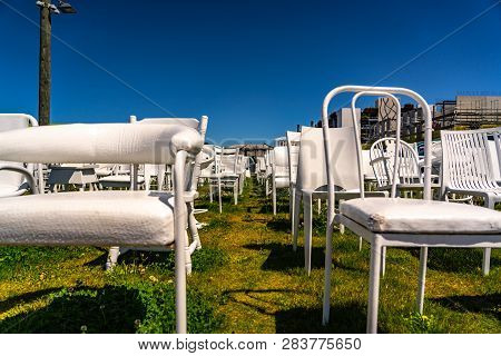 An Installation Of Empty White Chairs Constitutes An Unofficial Temporary Memorial For 185 People Wh