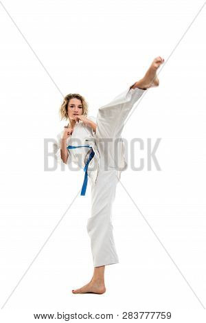 Full Body Of Woman Making Martial Arts Kicking Up Wearing White Outfit