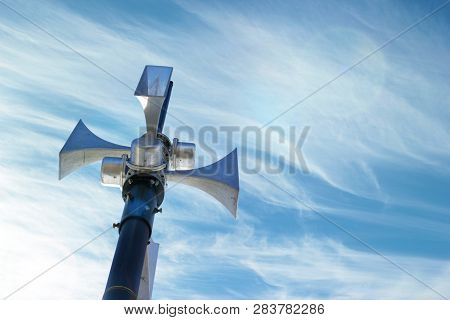 Public Address System Speakers, Against A Bright Blue Sky, With Space For Your Text