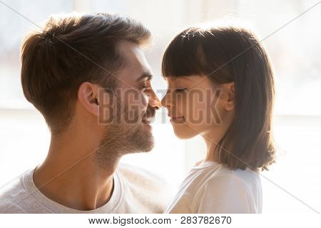 Happy Loving Father And Kid Daughter Touching Noses Enjoy Tenderness