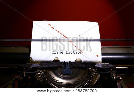 Typewriter Spelling Crime Fiction On Paper With Blood Splashes