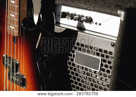 Beautiful And Perfect Polished Electric Guitar With Amplifier Standing In Audio Recording Studio. Mu