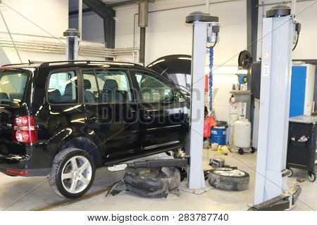Car Raised On Car Lift In Autoservice.