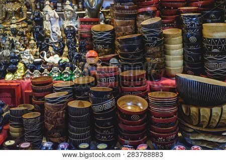 Different Hand Made Bowls And Various Statues Of The Gods Of Luck, A Fine Souvenirs Selling On A Loc