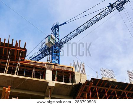 Commercial  Construction Project. Crane Near Building. Construction Site Background