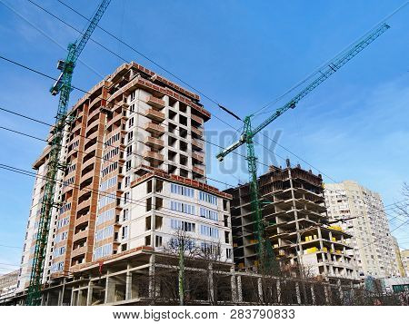 Construction Site Background. Commerxial Construction Project. Two Cranes Near Building Under Constr