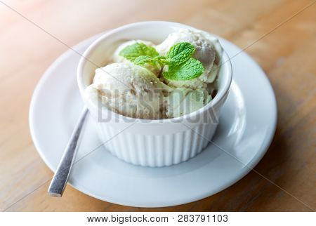 Milk Vanila Ice Creams With Mint Leaf  In White Cup With Morning Warm Lighting.
