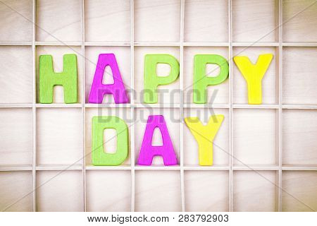 Happy Day Text From Colorful Letters Is On Wooden Board.