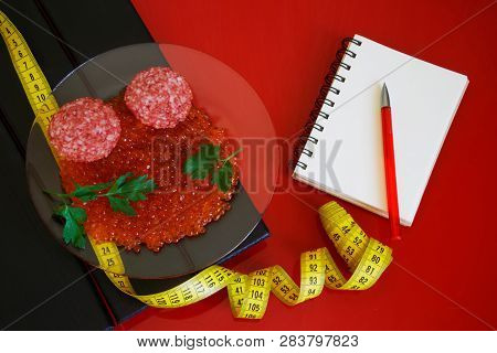 Red Caviar, Salami And Parsley Leaves Next To The Notepad And Tape Measure. Counting And Recording T