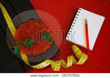 Red Caviar And Parsley Leaves Next To The Notepad And Tape Measure. Counting And Recording The Amoun