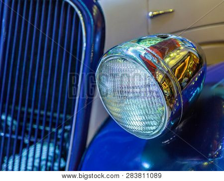 Headlight Of A Vintage Car With Fender And Grill