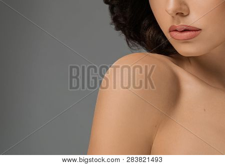 Cropped Close Up Nude Lips And Naked Shoulders. Seductive Beautiful Fashionable Model With Puffy, Pl