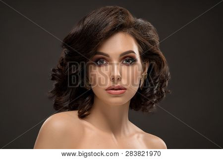 Glamour Elegant Handsome Woman Posing In Studio On Black Background. Brunette With Wolumed Hair, Nud