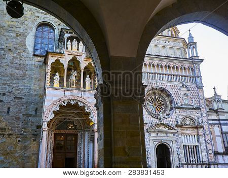 Main Facade Of The Basilica Di Santa Maria Maggiore And The Colleoni Chapel. View From Archway Of Th