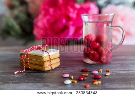 Baking Surprise Cookies With Topping And Icing On Wooden Background With Pink Heart And Cap With Mal