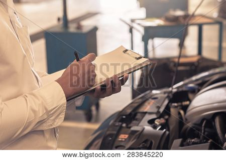 This Career Man Saleman Business Inspection Writing Note On Notepad Or Book, Paper With Car Blurry B
