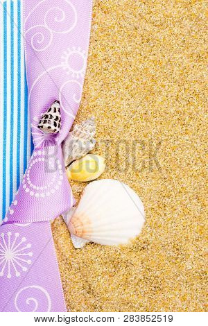 Holiday Gift Card With Violet Bow And Ribbon In The Middle Of Decoration With  Sea Shells On Backgro