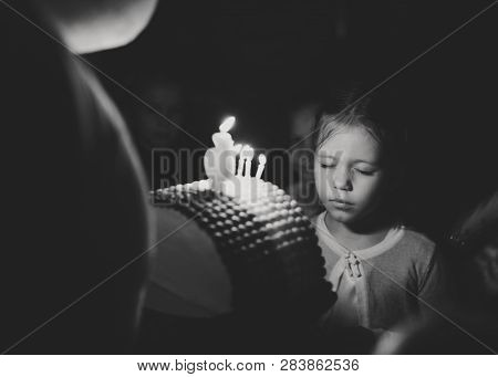 Girl With Birthday Cake With Caldles Wishing In Darkness