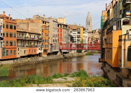 Colorful Houses And Eiffel Bridge (pont De Les Peixateries Velles) Reflected In Water River Onyar, B