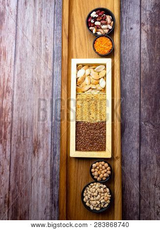 Different Kinds Of Bean Seeds, Lentil, Peas In Dish On Wooden Table, Macrobiotic Food Or Healthy Foo