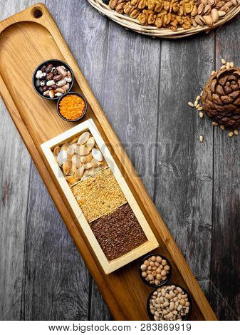 Cereal Grains: Red Lentils, Mung, Beans, Chickpea, Buckwheat On Wooden Kitchen Table With Flaxseeds,