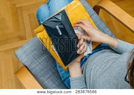 Paris, France - Nov 4, 2017: Female Photographer Unboxing On The Living Room Armchair The Amazon Pri