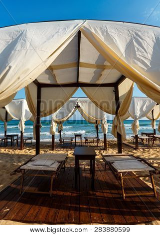 Beach Tents Canopies On Morning Paradise White Sandy Sea Beach, Apulia, Italy.